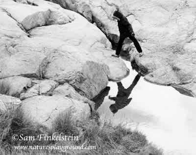 Boy Leaps Across Stream